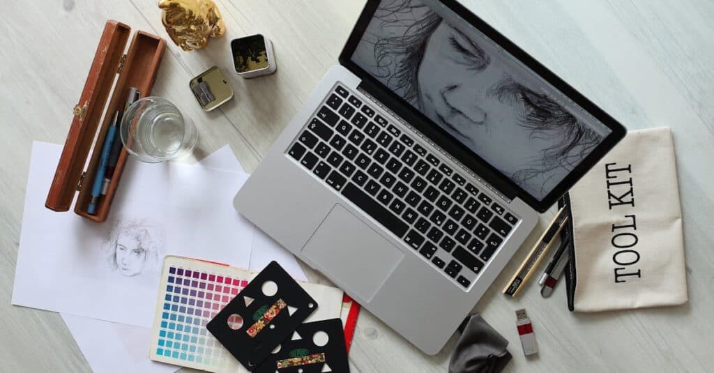 pexels-photo-414974-414974 Top view of a creative workspace with a laptop, sketch supplies, and color palette.