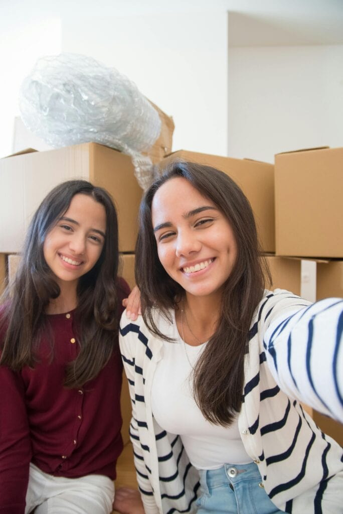 Indian GenZ girls packing boxes for moving out at 22